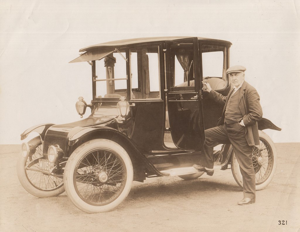 Thomas Edison standing beside an early Detroit Electric automobile